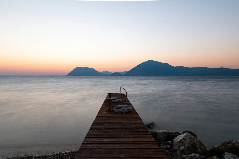 there is a pier leading to a large body of water