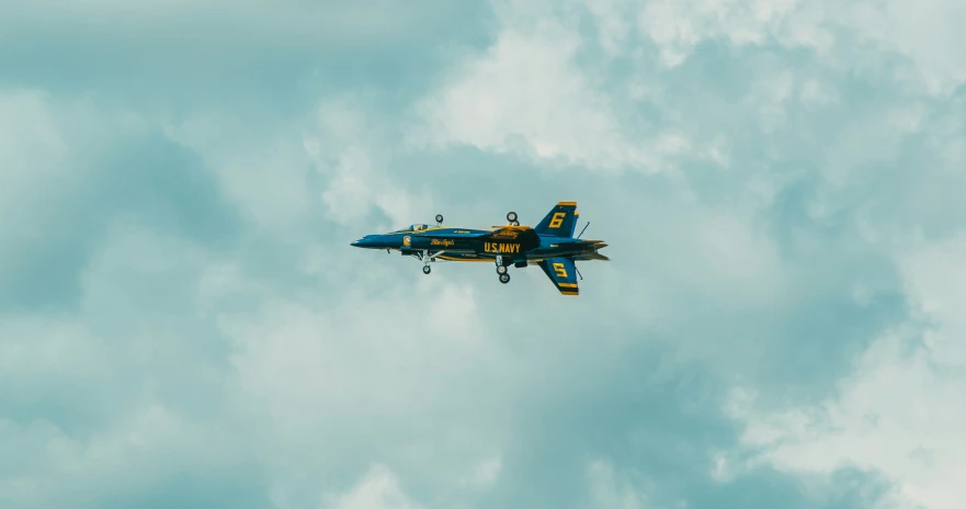 an airplane flying through the air on a cloudy day