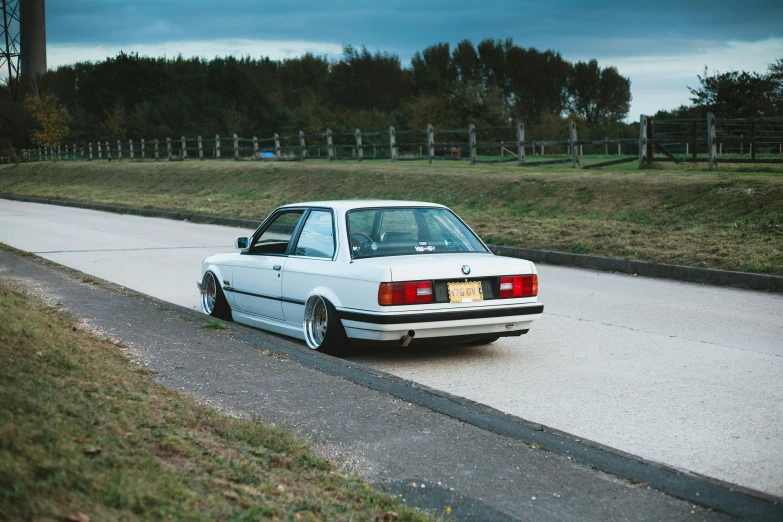 a white car parked on the side of a road