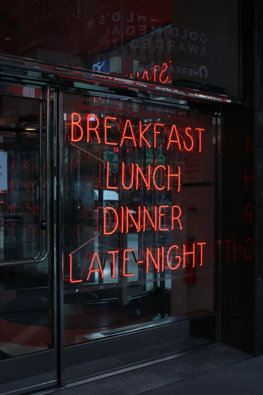 the neon sign outside the restaurant indicates it is lunch