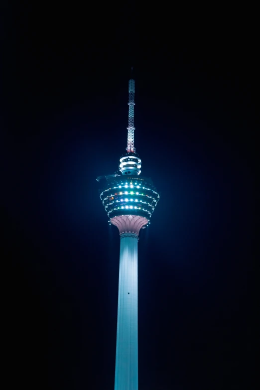 the top view of a tall tower lit up at night