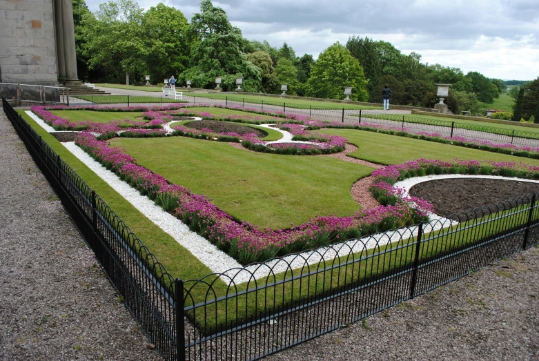 a garden with a circle pattern of lavender flowers