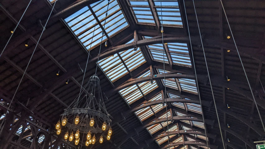 the ceiling inside of a station with lights and signs