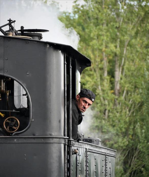 a man looking out of the window of a train