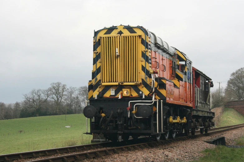 a locomotive car is painted red and yellow