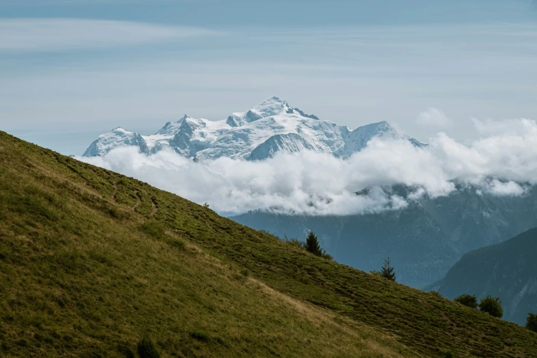 the mountains are covered with snow and clouds