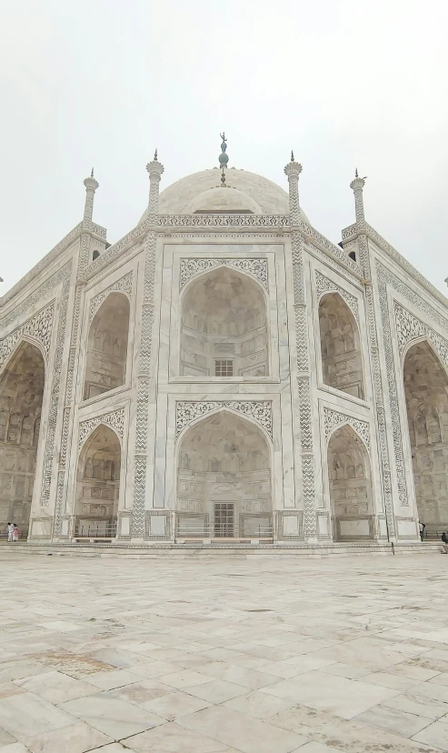 the entrance of a stone building that has columns and arches