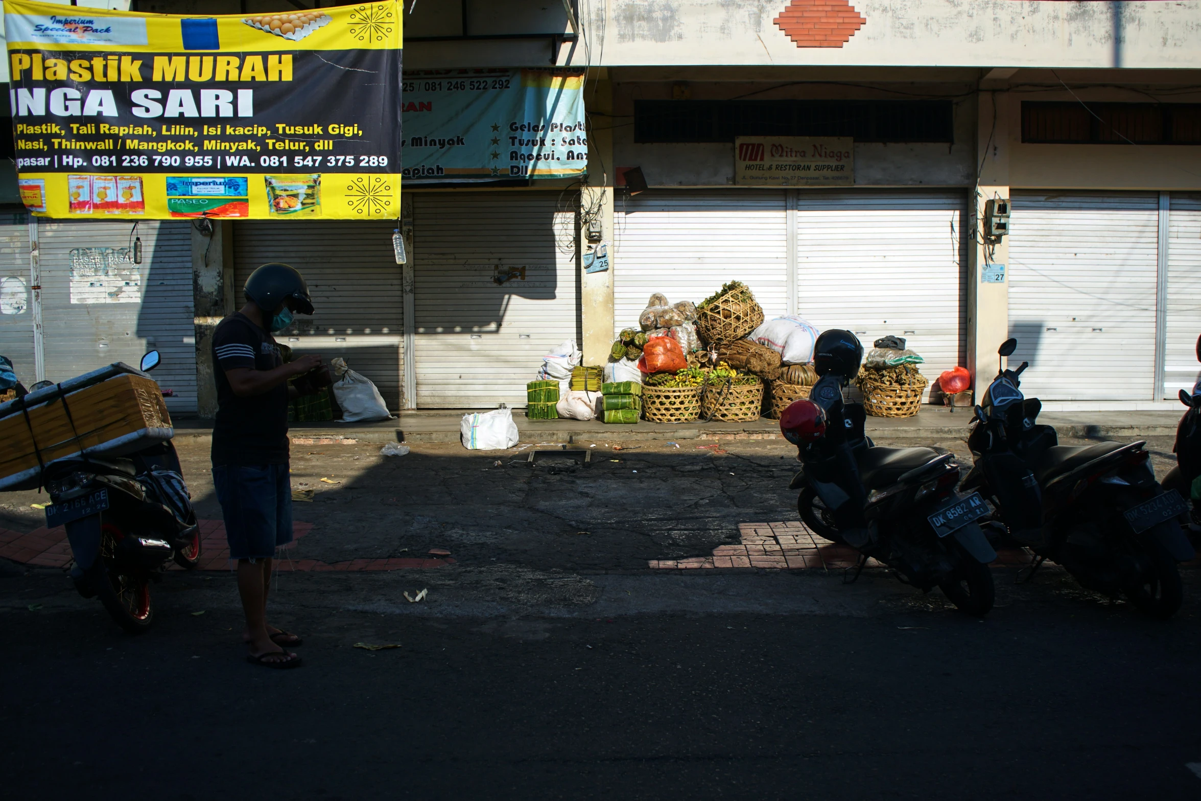 a man with no head is near some parked motorcycles