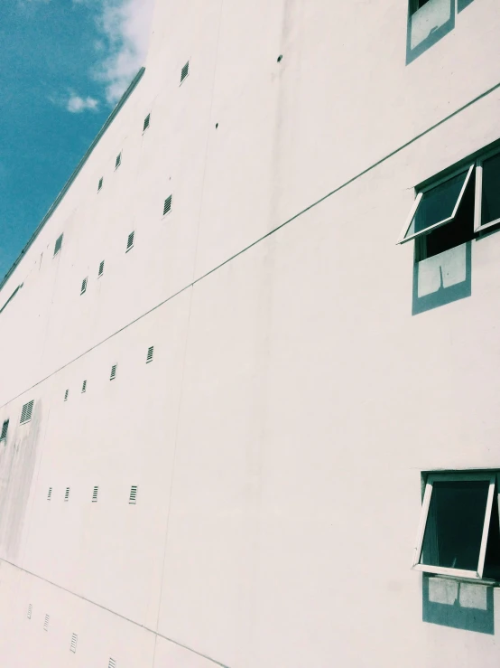 a white building with two windows on the side of it