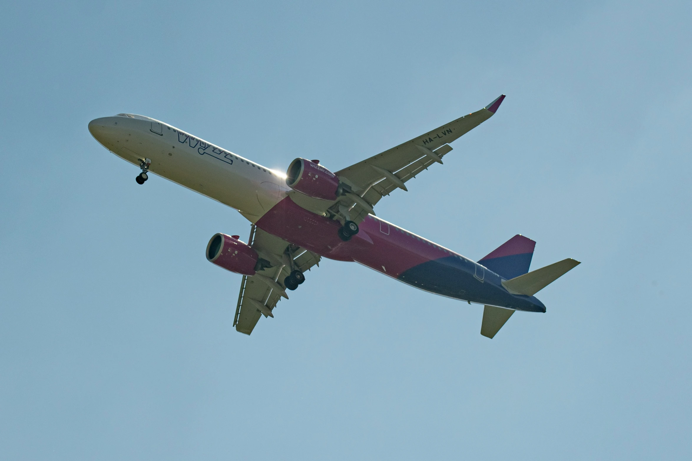 an air plane flying in a blue sky