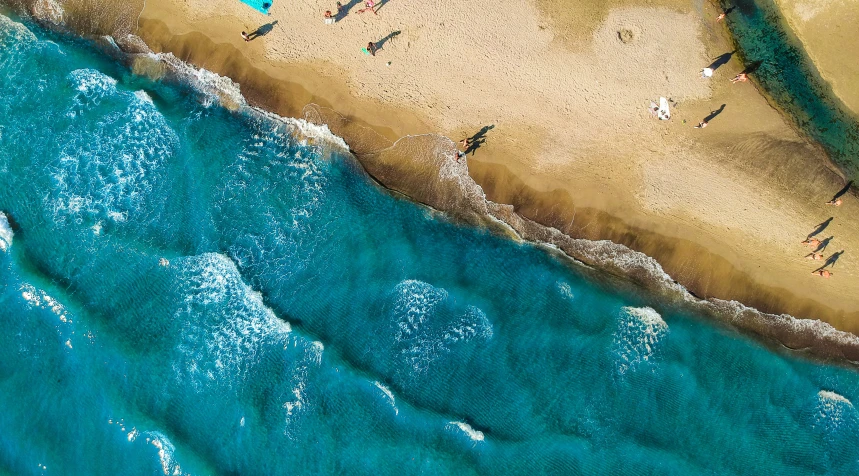 people in the beach laying on their back as if at the water