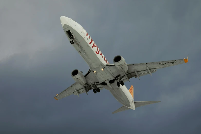 a commercial plane flying thru a cloudy sky