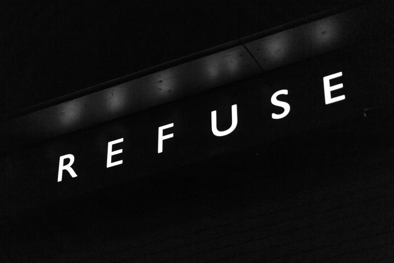 a neon sign that reads refuse on the wall