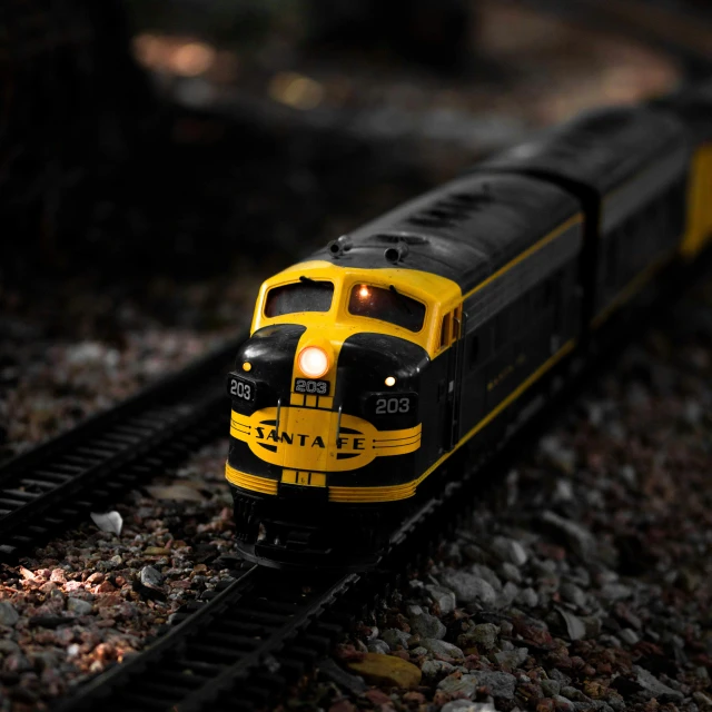 a black and yellow train traveling down a track