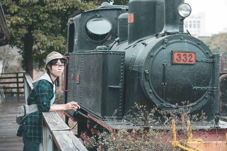 a lady standing on the side of a train next to a woman