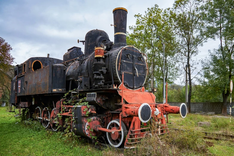 an old train sits on a grassy field