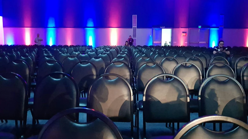 a room with many chairs that are near each other