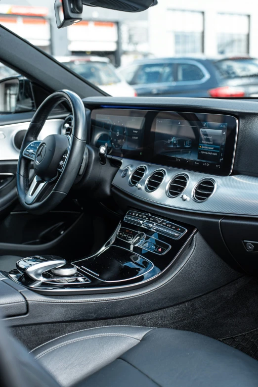 a car dashboard with a steering wheel and the center console