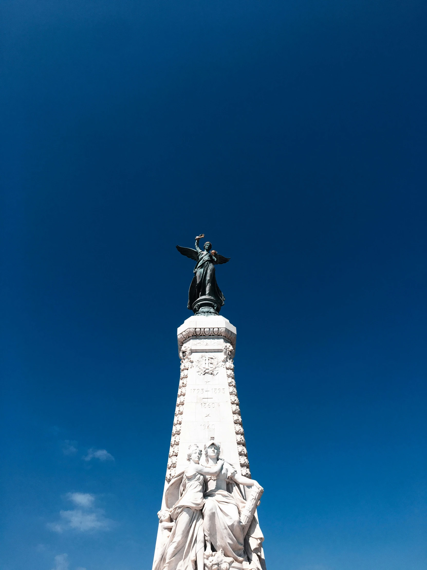 the large white statue is by the large clock