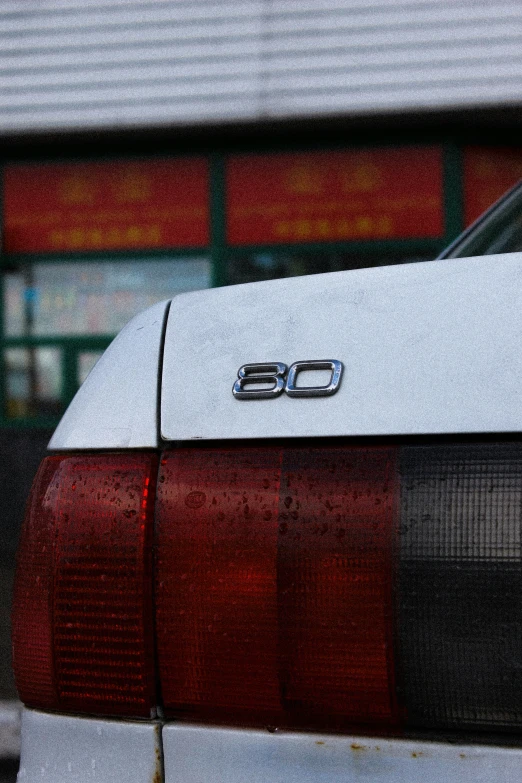 the rear end of a car with snow on the hood