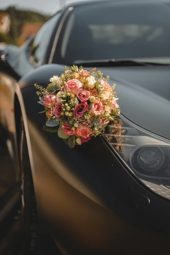 some kind of flower bouquet sitting on a car