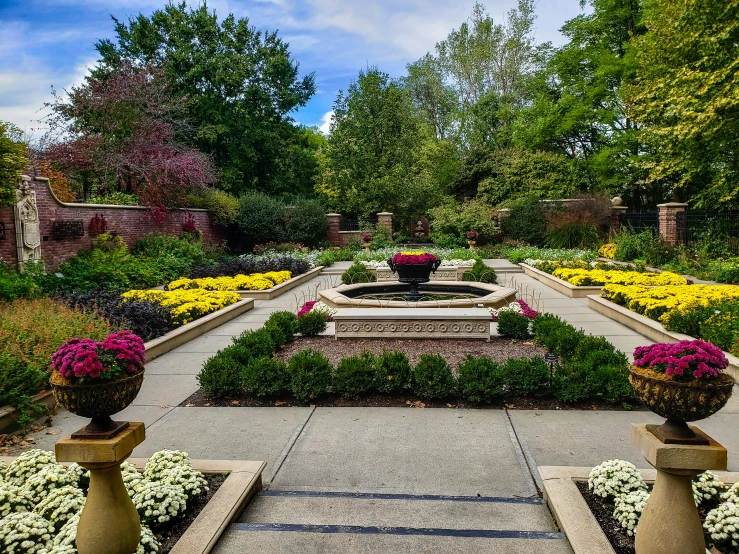 there is a bench in the center of this garden