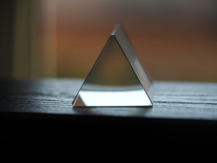 a white triangular shaped object sitting on top of a table