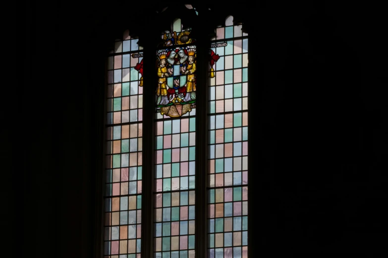 the stain glass has an angel and a flower on it