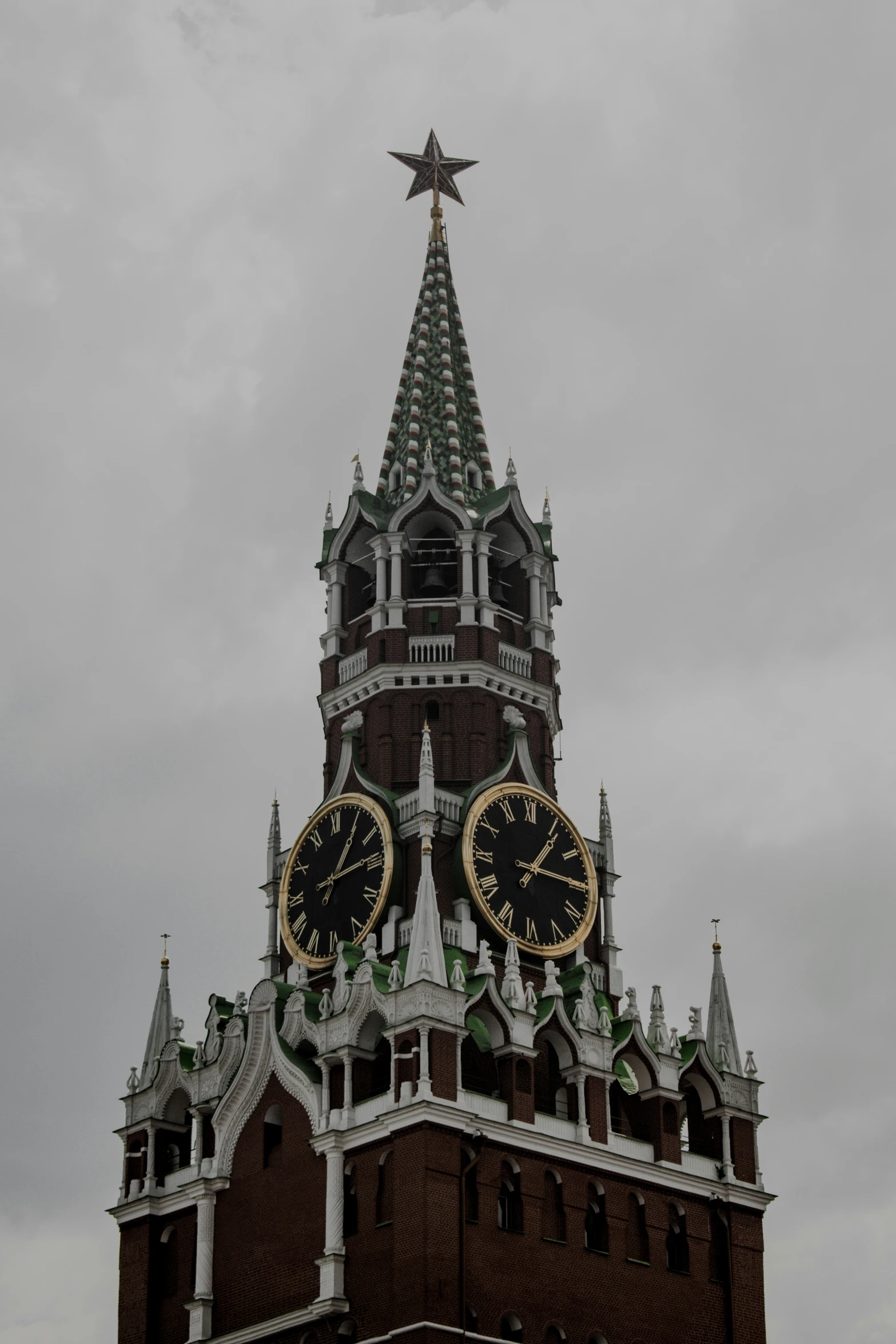 two large clocks are on the sides of a building