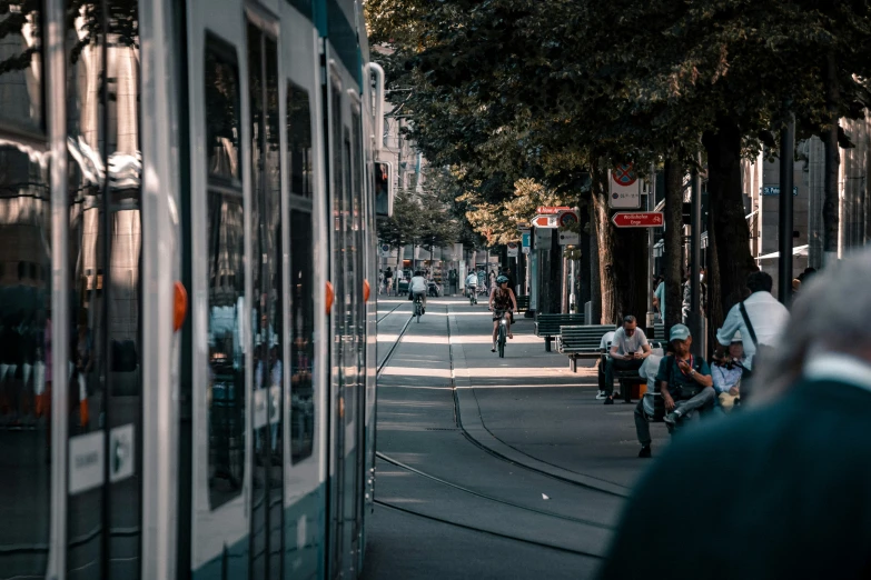 the people are riding down the street with bicycles