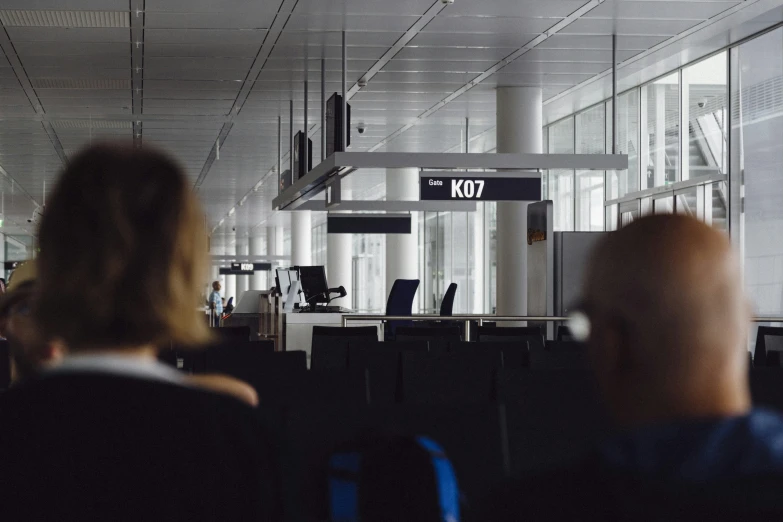 an airport waiting area with people waiting in line