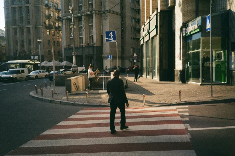 a man crossing a street at a crosswalk