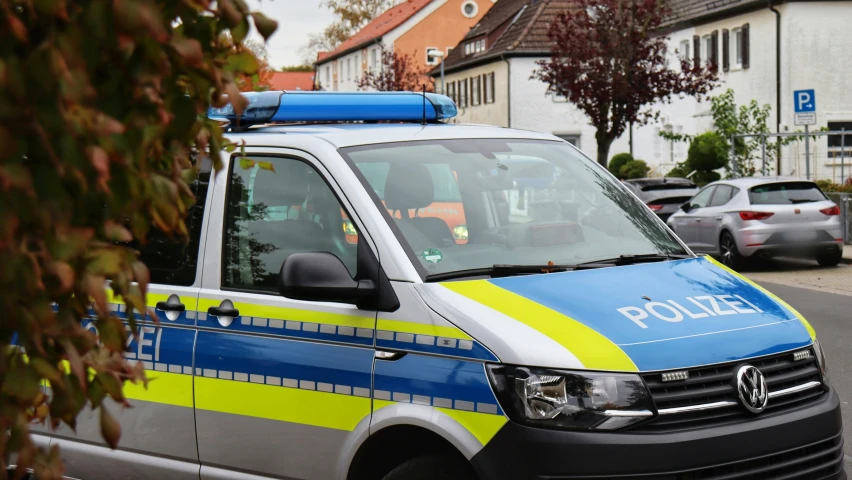 a police car is parked in front of some houses