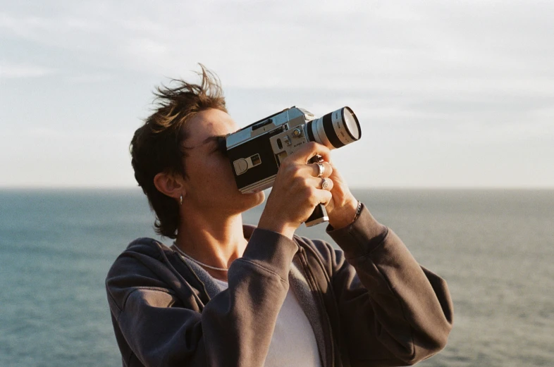 a woman on a beach is taking a po with a camera