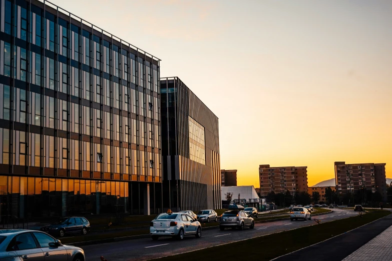 cars traveling on the road during sunset in the city