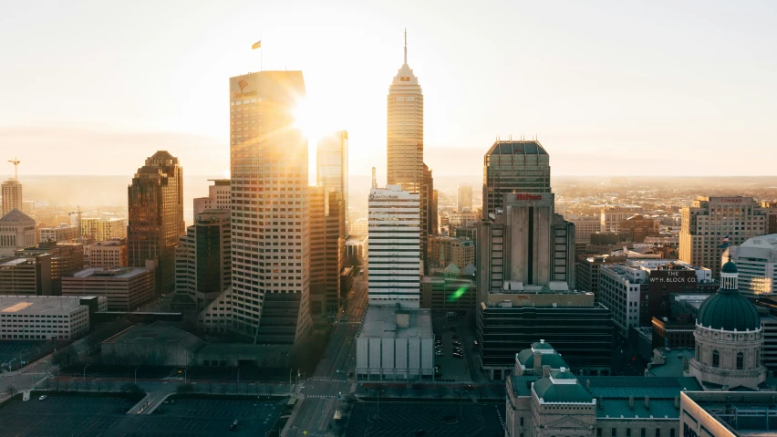 a large city with skyscrs with the sun peaking in