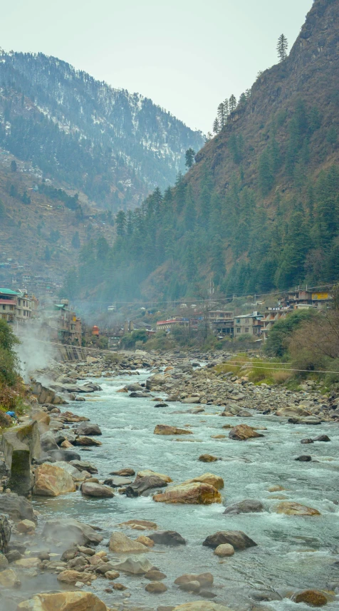 the mountains near the town are covered with mist