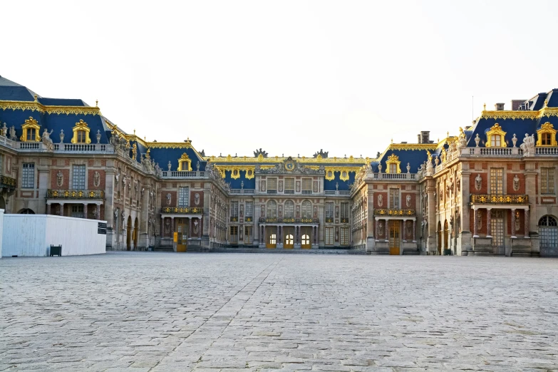 a large building is in front of a brick road