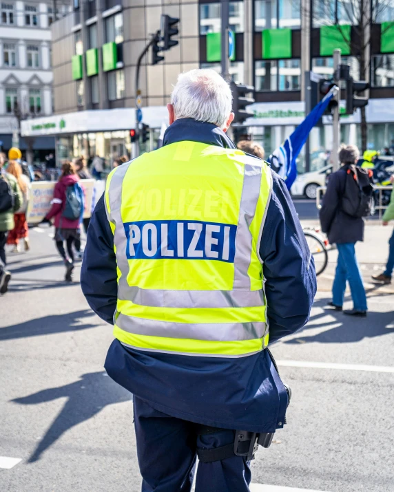 a police officer is directing people around in the street