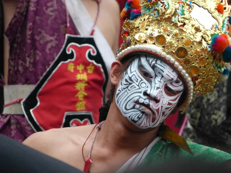 a man with a painted face and a hat