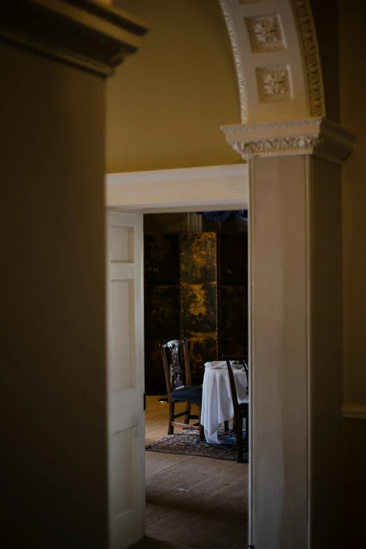 a table with white cloth is set up in an archway