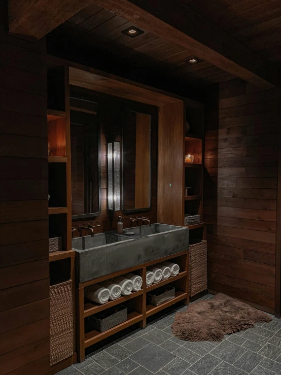 a dark wood bathroom has a large sink