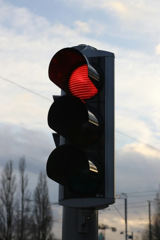 two red traffic lights on a street post