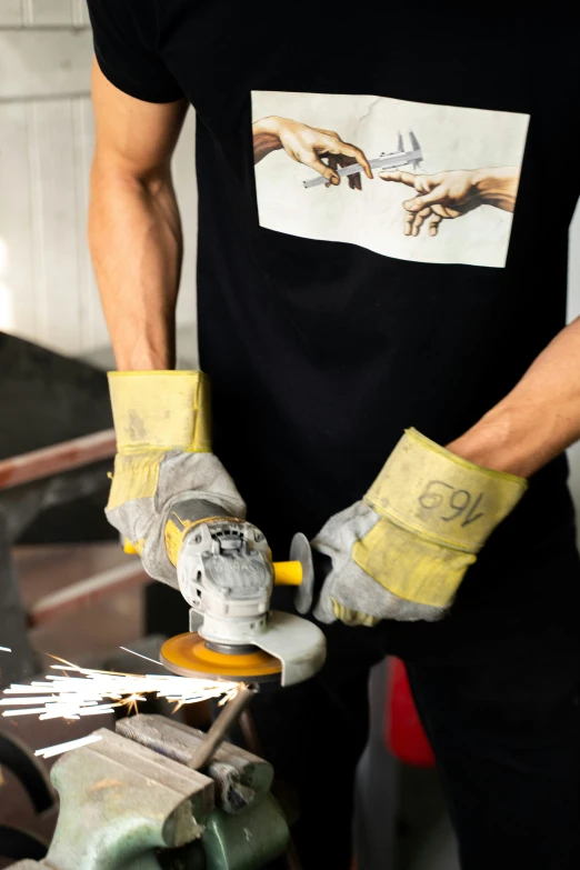 a man sanding a skateboard with yellow gloves