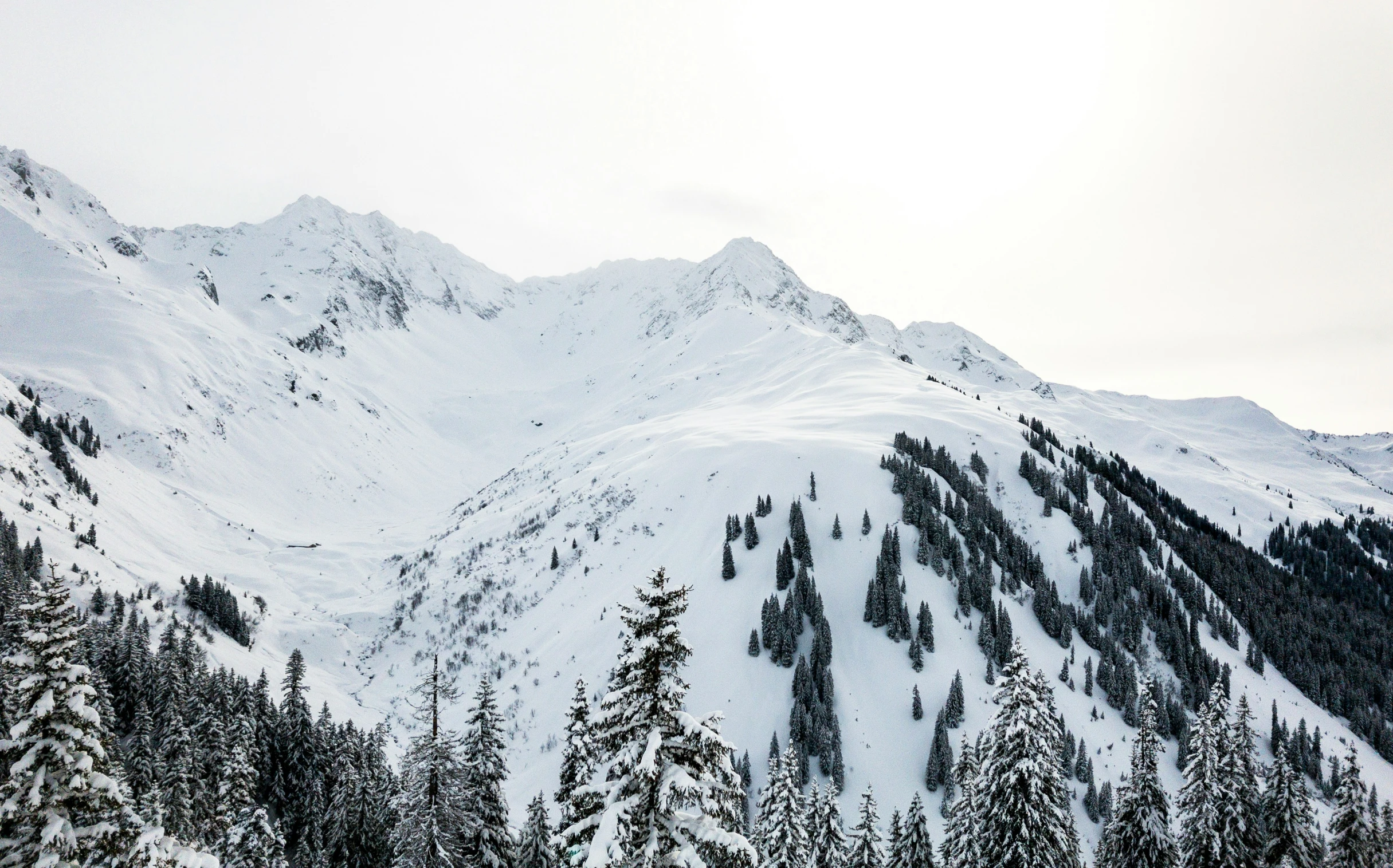 the top of a mountain covered in snow