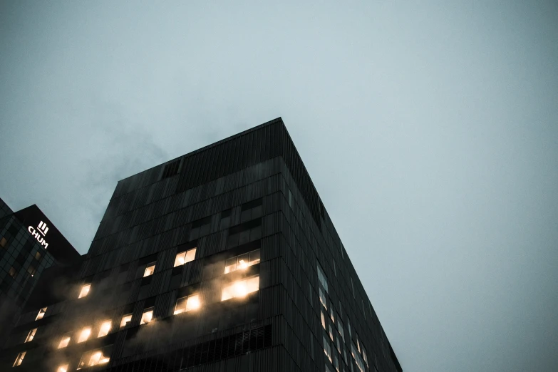 the top of a tall black building on an overcast day