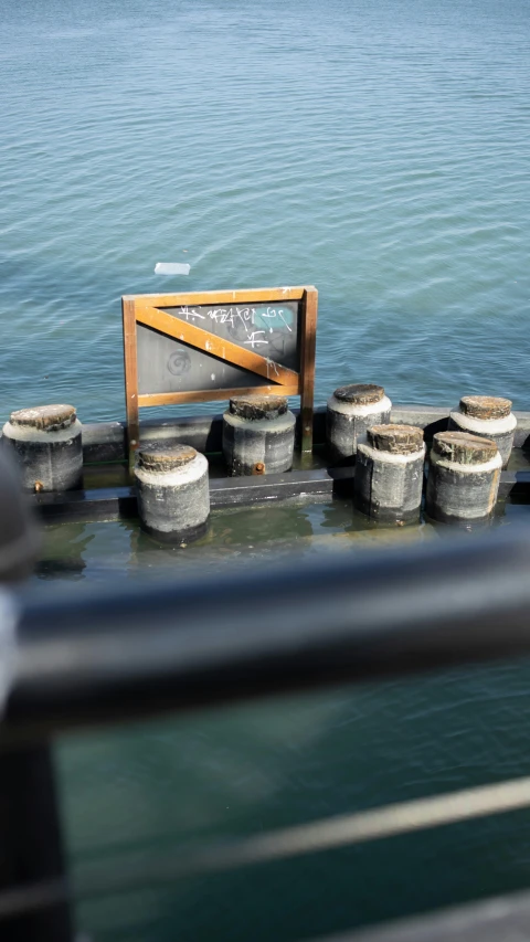 some concrete blocks in the water near a sign