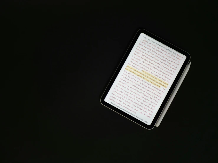 an open book on a table with writing in yellow