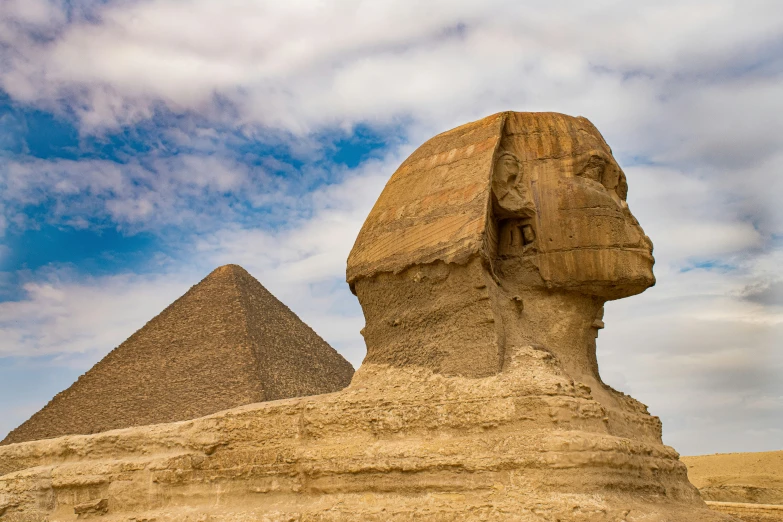 a large statue of an egyptian god and a big sphinx