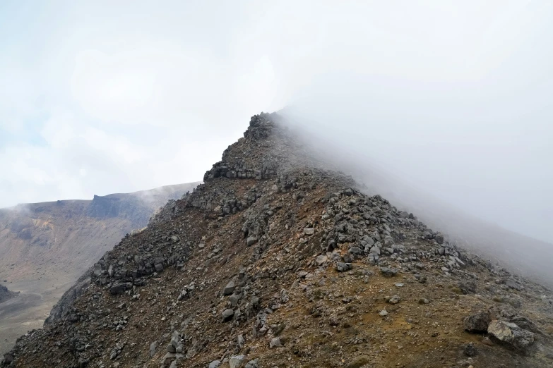 a rocky slope with very low clouds blowing